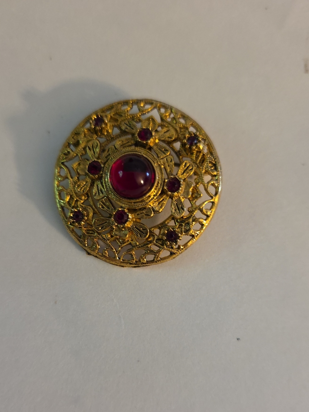 Gold-Tone Floral Filigree Brooch with Deep Red Cabochon